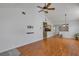Open-concept living room with wood floors, vaulted ceilings and view of kitchen and dining at 2227 Doulton Dr, Orlando, FL 32812
