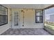 Outdoor patio featuring overhead string lights, a glass paneled door, and neutral siding at 2227 Doulton Dr, Orlando, FL 32812
