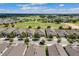 High angle aerial view of multiple homes with a well-maintained golf course behind them at 2233 Antilles Club Dr, Kissimmee, FL 34747