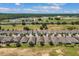 A high-angle view showcases houses lining a golf course with a highway and buildings in the distance at 2233 Antilles Club Dr, Kissimmee, FL 34747