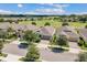 Aerial view of several homes with tan roofs and a large golf course in the background at 2233 Antilles Club Dr, Kissimmee, FL 34747