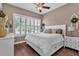 Comfortable bedroom with large window, decorative headboard, and calm color palette for relaxation at 2233 Antilles Club Dr, Kissimmee, FL 34747