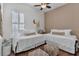 Bright bedroom features two cozy beds, warm wood floors, and neutral decor for a peaceful retreat at 2233 Antilles Club Dr, Kissimmee, FL 34747