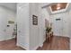 Well lit foyer featuring hardwood floors, white walls, and an ornate light fixture on the ceiling at 2233 Antilles Club Dr, Kissimmee, FL 34747