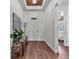 Inviting foyer featuring hardwood floors, a decorative light fixture, and ample natural light at 2233 Antilles Club Dr, Kissimmee, FL 34747