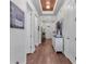 Elegant foyer boasts hardwood floors, decorative light fixture, and ample natural light at 2233 Antilles Club Dr, Kissimmee, FL 34747