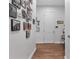 Hallway featuring wood flooring and a wall with decorative artwork and Gathering photos at 2233 Antilles Club Dr, Kissimmee, FL 34747