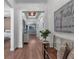 Hallway featuring hardwood floors, a decorative light fixture, and access to multiple rooms at 2233 Antilles Club Dr, Kissimmee, FL 34747