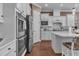 Kitchen featuring sleek stainless steel appliances, white cabinets, and complementary countertops at 2233 Antilles Club Dr, Kissimmee, FL 34747