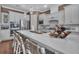 Spacious kitchen features a large quartz island with seating and stainless steel appliances and accents at 2233 Antilles Club Dr, Kissimmee, FL 34747