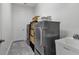 Well-organized laundry room featuring a washer, dryer, storage baskets, and a utility sink at 2233 Antilles Club Dr, Kissimmee, FL 34747