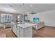 Bright, open-concept living room with hardwood floors and comfortable sectional sofa extending to island at 2233 Antilles Club Dr, Kissimmee, FL 34747