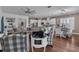 Spacious living space with hardwood floors, comfortable seating, and open layout into kitchen and dining areas at 2233 Antilles Club Dr, Kissimmee, FL 34747
