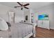 Main bedroom features wood flooring, a TV, and access to an ensuite bathroom and kitchen at 2233 Antilles Club Dr, Kissimmee, FL 34747