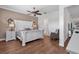 Charming main bedroom features a decorative headboard, warm wood floors, and a serene color palette at 2233 Antilles Club Dr, Kissimmee, FL 34747