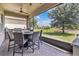 Enjoy outdoor dining on the screened patio with a ceiling fan and stainless steel grill at 2233 Antilles Club Dr, Kissimmee, FL 34747
