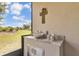 Outdoor kitchen with granite countertop, sink, stainless steel cabinets, and serene backyard views at 2233 Antilles Club Dr, Kissimmee, FL 34747