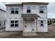 New construction features a two-story house with a covered porch and installed windows at 2365 Zuni Road, St Cloud, FL 34771