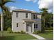 Charming two-story home with gray siding, lush landscaping, and a welcoming front porch at 2365 Zuni Road, St Cloud, FL 34771