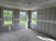 Bright, unfinished living room with three windows offering great natural light, still under construction at 2365 Zuni Road, St Cloud, FL 34771