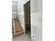 Unfinished staircase with natural wood stairs and drywall, showing the early stage construction of the home at 2365 Zuni Road, St Cloud, FL 34771