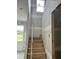 Unfinished staircase with natural wood steps leading to the upper level, highlighting the home's construction phase at 2365 Zuni Road, St Cloud, FL 34771