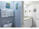 This bathroom showcases a toilet, vanity with granite countertop, and cartoon art at 271 Jetty Way, Davenport, FL 33897