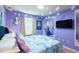 Bright 'Frozen' themed bedroom features a blue bedspread, themed art, and decorative snowflakes at 271 Jetty Way, Davenport, FL 33897
