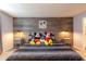 Cheerful Disney-themed bedroom featuring gray furnishings, wood accent wall and twin bedside tables at 271 Jetty Way, Davenport, FL 33897