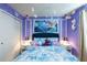Cozy 'Frozen' themed bedroom featuring a blue bedspread, themed art, and decorative snowflakes at 271 Jetty Way, Davenport, FL 33897
