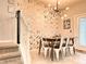 Bright dining room features a modern light fixture and lovely wallpaper accents at 271 Jetty Way, Davenport, FL 33897