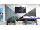 Well-appointed game room with foosball table, air hockey and wall mounted TV at 271 Jetty Way, Davenport, FL 33897