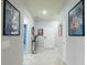Bright hallway featuring Disney decor, tile flooring, a console table, and a white front door at 271 Jetty Way, Davenport, FL 33897