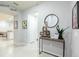 Inviting hallway with tile floors, console table, and Disney art, providing access to various rooms at 271 Jetty Way, Davenport, FL 33897