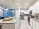 Modern kitchen with stainless steel appliances, granite countertops and island seating at 271 Jetty Way, Davenport, FL 33897