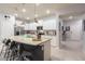Bright kitchen featuring stainless steel appliances, island with seating, and stylish lighting at 271 Jetty Way, Davenport, FL 33897
