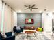Inviting living room featuring cozy seating, stylish decor, and a modern ceiling fan at 271 Jetty Way, Davenport, FL 33897