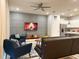 Cozy living room with stylish decor, a modern ceiling fan, and a mounted TV above an entertainment console at 271 Jetty Way, Davenport, FL 33897