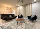 Stylish living room featuring a modern light fixture, comfortable seating, and an accent rug on tile flooring at 271 Jetty Way, Davenport, FL 33897