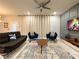 Cozy living room featuring a comfortable seating area, a decorative ceiling fan, and ample natural light at 271 Jetty Way, Davenport, FL 33897