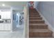 Carpeted staircase with white banister leading to the upper level of the home at 271 Jetty Way, Davenport, FL 33897