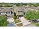 Aerial view of a lovely two-story home with a two-car garage and mature trees on a sunny day at 2850 Pewter Mist Ct, Oviedo, FL 32765
