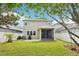 View of backyard showing screened porch, patio, and grassy lawn enclosed by a white fence at 2850 Pewter Mist Ct, Oviedo, FL 32765