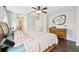 Bedroom boasts a wooden dresser and hardwood flooring, plus a large bed and mirror at 2850 Pewter Mist Ct, Oviedo, FL 32765