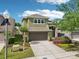 Charming two-story home with manicured landscaping, a two-car garage, and a welcoming entrance at 2850 Pewter Mist Ct, Oviedo, FL 32765