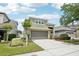 Beautiful two-story home with a well-manicured lawn and inviting two-car garage on a sunny day at 2850 Pewter Mist Ct, Oviedo, FL 32765