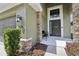 Inviting front porch with stone accents, dark door, and updated landscaping at 2850 Pewter Mist Ct, Oviedo, FL 32765