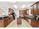 Spacious kitchen with dark wood cabinets, granite countertops, and stainless steel appliances at 2850 Pewter Mist Ct, Oviedo, FL 32765