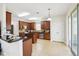 Well-lit kitchen with granite countertops, stainless appliances, and ample cabinet space, perfect for cooking at 2850 Pewter Mist Ct, Oviedo, FL 32765