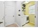 Functional laundry room with modern washer and dryer, shelving, and ample space for storage at 2850 Pewter Mist Ct, Oviedo, FL 32765